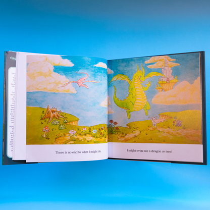 Open book with colorful illustrations of a dragon and landscape on a blue background
